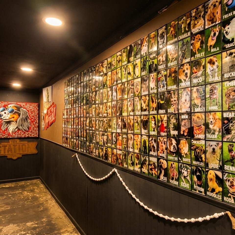 A long, narrow hallway with a wall covered in framed photos of dogs, and a dog mosaic.
